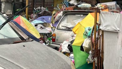 Photo of Within the pile of garbage, there is a car!